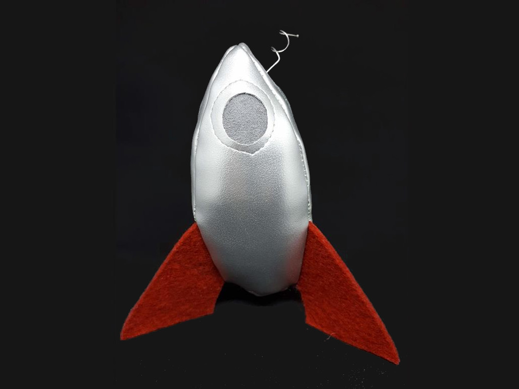 A silver rocketship with angled red fins.