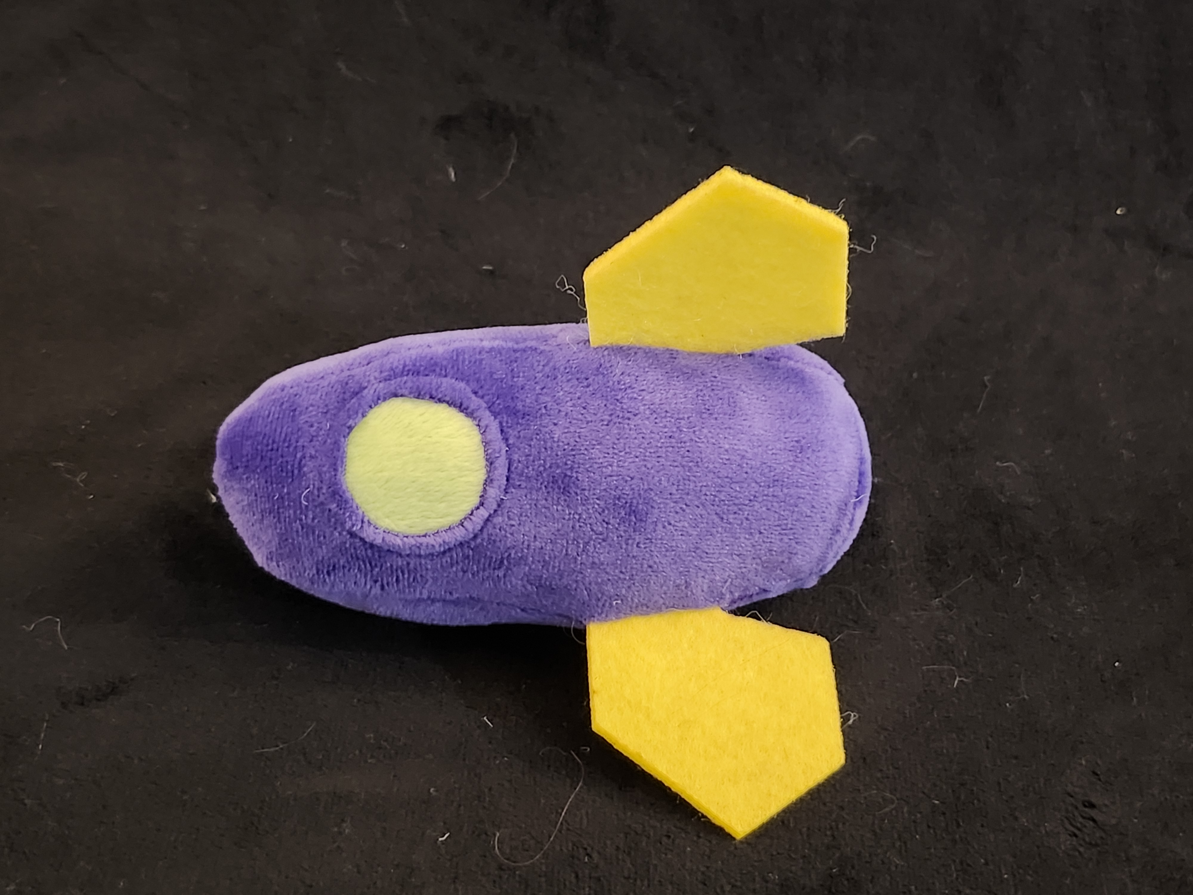 Small purple rocket with yellow fins.