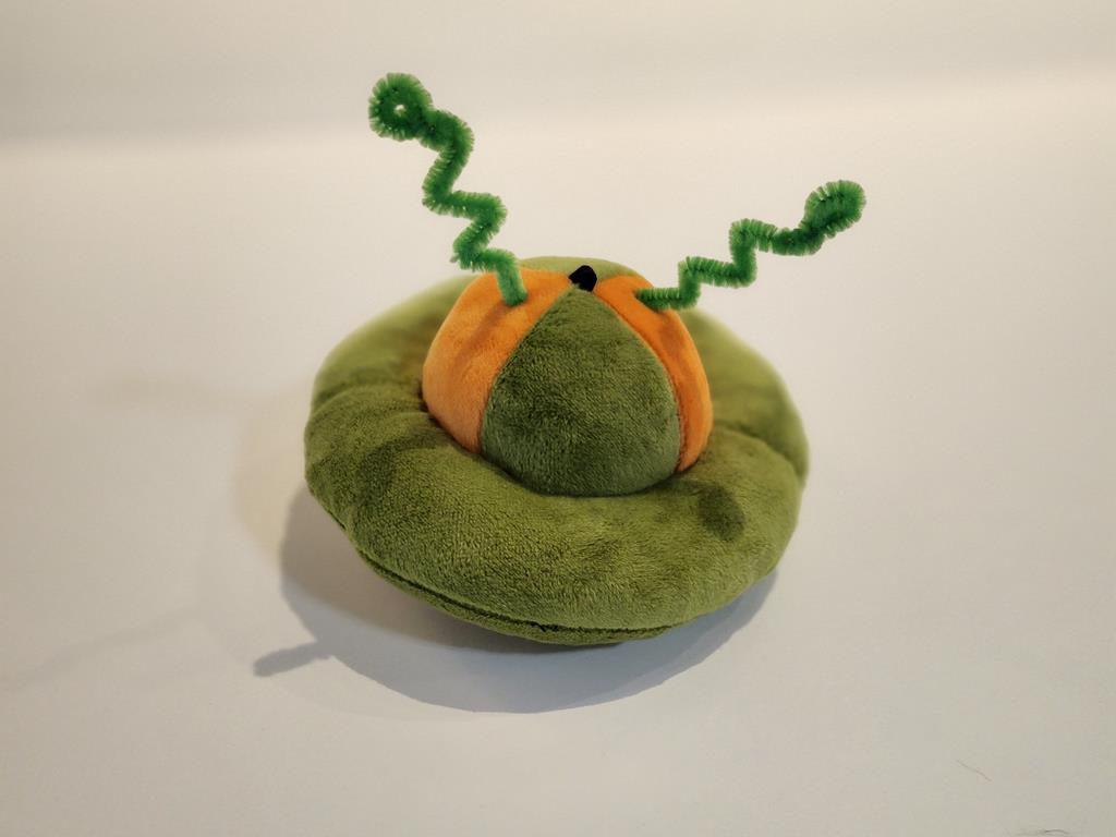 A green and orange flying saucer