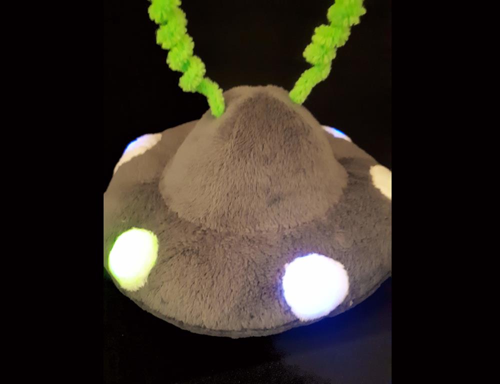 A grey flying saucer with lights